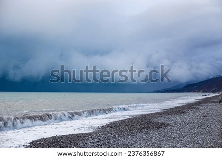 Storm waves on the Black Sea coast. Huge waves under gray skies. Stormy weather.