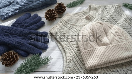 Winter clothes. Gloves, sweater and beanie.A sunny room.