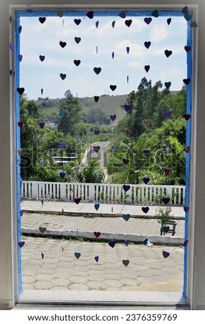 Glass window with colorful heart curtain