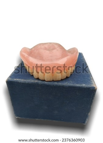 A removed dentures on top of the box Royalty-Free Stock Photo #2376360903