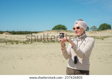 Woman remove a camera on vacation