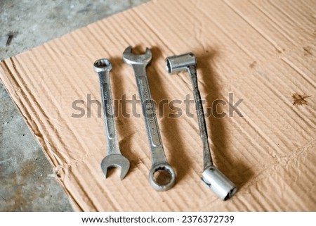 Mixed set wrench laying on the cardboard Royalty-Free Stock Photo #2376372739