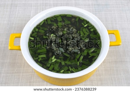 Close up of Daesuritang(marsh snail soup) with flesh and chives on bowl, South Korea
