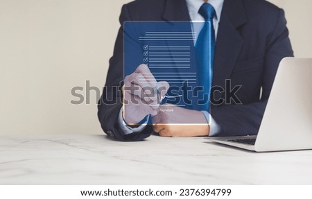 Electronic signature. A Businessman signing a lease contract or agreement on a virtual screen while sitting at the table in the office. Close-up photo. Business and documents management concept