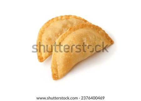 Curry puff or Fried Pastel is a popular dry cake in Indonesia. Fried pastries filled with potatoes and carrots isolated on a white background Royalty-Free Stock Photo #2376400469