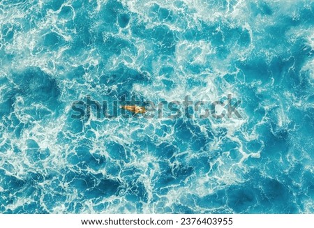 Woman surfer in a deep ocean on a short surfboard in Hawaii aerial Royalty-Free Stock Photo #2376403955