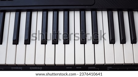 Close-up of piano keys. Piano black and white keys and Piano keyboard musical instrument placed at the home balcony during sunny day.