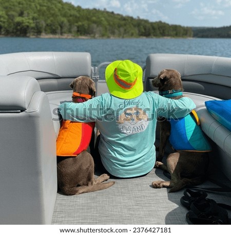 Chunky, Sissy and Di on the Pontoon Boat on the Lake on Holiday in Their Life Jackets Having Great Fun ! Royalty-Free Stock Photo #2376427181