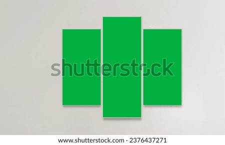 Picture frame on a green screen placed on  wall photo wooden frames with green screen on off white colored .The picture frame on the wall has a green screen to insert content or pictures.