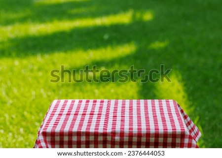 Empty garden table with lush backdrop. Mockup template for your product