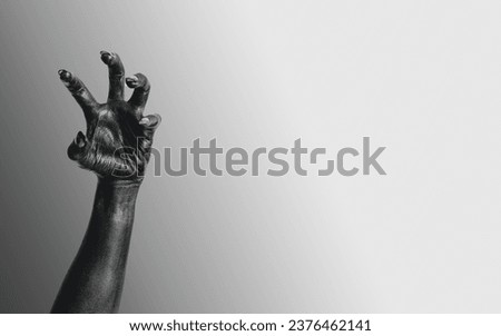 Black Devil Creepy Scary Monster Halloween Hand isolated on a grey background. Concept of murder. Horror Scene with Bloody Hand. closeup Black Hands with Long Nails death. Creepy monster claw. violanc