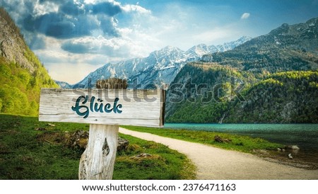 picture shows a signpost and a sign pointing towards luck in german. Royalty-Free Stock Photo #2376471163