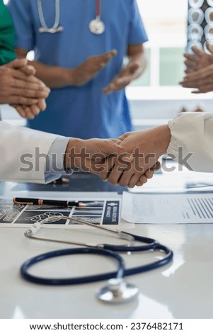 Medical team joins hands in medical meeting treating sick people and service guidelines vertical picture