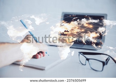 Double exposure of Man writing in notepad with business icons on background. Concept of international business.