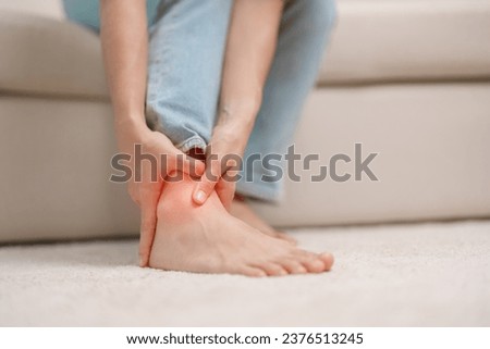 woman having leg pain due to Ankle Sprains or Achilles Tendonitis and Shin Splints ache. injuries, health and medical concept Royalty-Free Stock Photo #2376513245