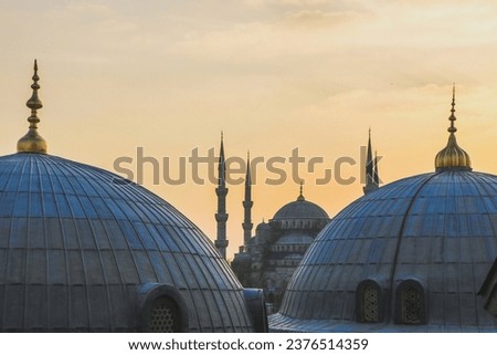View of Sultanahmet Imperial Mosque, Sultan Ahmet Camii. Blue Mosque domes and minarets in Istanbul, Turkey at sunset. Royalty-Free Stock Photo #2376514359
