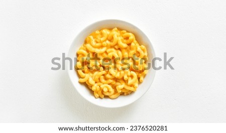 Macaroni and cheese in bowl over white background with copy space. Top view, flat lay Royalty-Free Stock Photo #2376520281