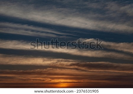 Beautiful colorful dramatic sky with clouds at sunset or sunrise.