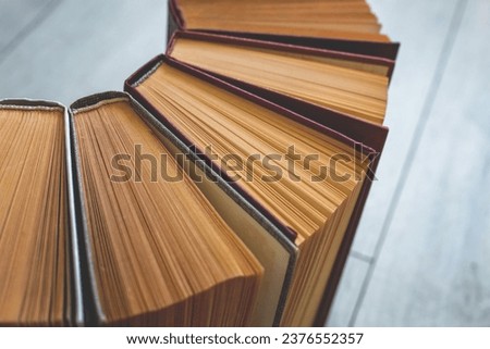 Multi-page hardcover book volumes with beige pages. Library, university, college, knowledge and information preservation concept. Reading culture, education. Background, texture