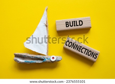 Build Connections symbol. Concept word Build Connections on wooden blocks. Beautiful yellow background with boat. Business and Build Connections concept. Copy space