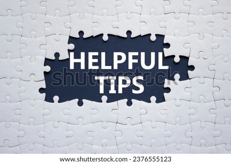 Helpful tips symbol. White puzzle with words Helpful tips. Beautiful dark blue background. Business and Helpful tips concept. Copy space.