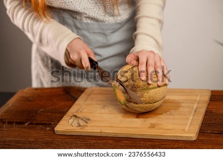 female hands holding a melon