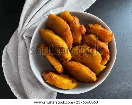 Greek fried tiganites with polenta, raisins and served with honey, aerial food photography, dessert picture of fried sweet patties