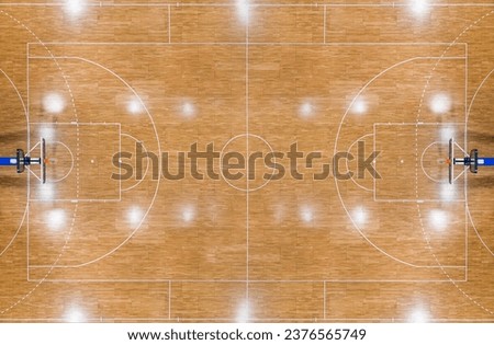 Top view of a parquet basketball court with hoops installed and reflections from lighting Royalty-Free Stock Photo #2376565749