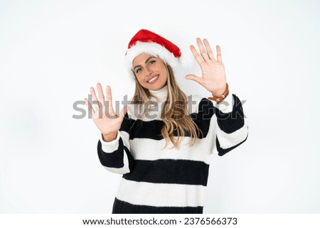 Young beautiful woman showing and pointing up with fingers number ten while smiling confident and happy.