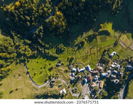 Aerial panoramic view of Khala valley with traditional village Tsvirmi, Tetnuldi peak in the Greater Caucasus Mountain Range, and Laila Peak of the Svaneti Mountains, Samegrelo-Upper Svaneti, Georgia