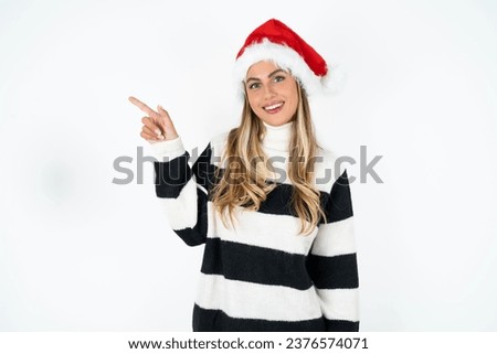 Young beautiful woman looking at camera indicating finger empty space sales