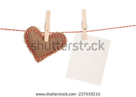 Photo frame and valentines day toy heart hanging on rope. Isolated on white background