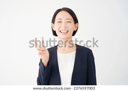 Asian middle aged businesswoman peace sign gesture in white background