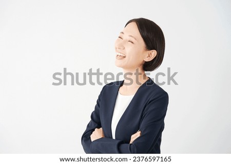 Portrait of Asian middle aged businesswoman smiling in white background