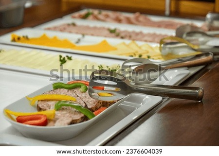 Breakfast in a business hotel, view of the morning food menu. Wide selection of cheese and fruit. Healthy breakfast. Small depth of field, detail. Royalty-Free Stock Photo #2376604039