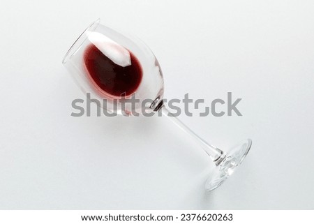 One glasses of red wine at wine tasting. Concept of red wine on colored background. Top view, flat lay design. Royalty-Free Stock Photo #2376620263