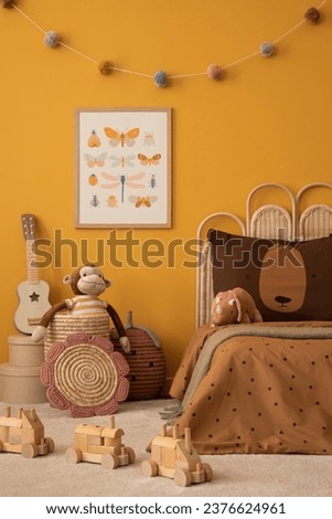 Aesthetic composition of child room interior with mock up poster frame, braided basket, guitar, wooden block toys, plush monkey, colorful garland and personal accessories. Home decor. Template.