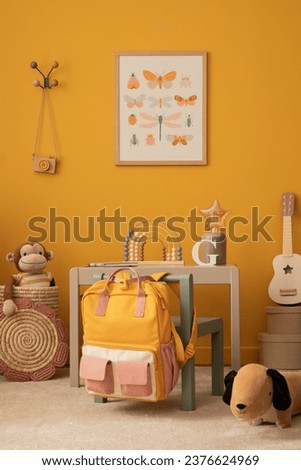 Cozy kid room interior with mock up poster frame, gray desk, green chair, plush monkey, dog, braided basket, guitar, star lamp, beige rug, sculpture and personal accessories. Home decor. Template. 