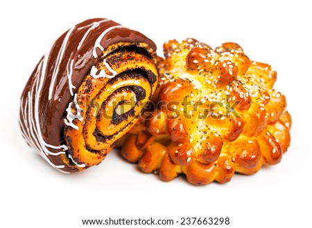 Fresh and tasty buns with with sesame and poppy seeds and roll with chocolate over white background