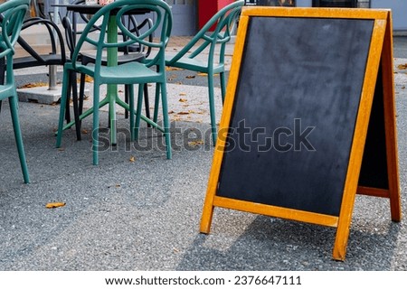 Blank Sandwich Board at the Street Near Cafe Or Pub. Business Center, Commercial Center, Downtown. Copy Space, Empty Space for Advertising