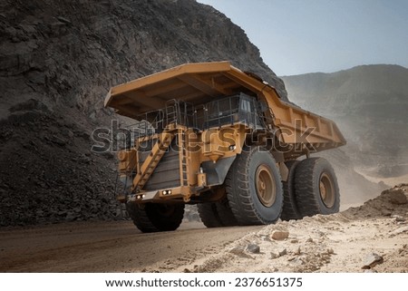 Mining trucks, also known as haul trucks or dump trucks, play a crucial role in the mining industry by transporting large quantities of materials, such as ore, overburden, or waste. Royalty-Free Stock Photo #2376651375