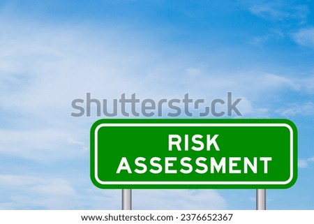 Green color transportation sign with word risk assessment on blue sky with white cloud background