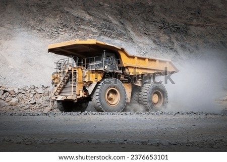 Mining trucks are designed for off-highway use, meaning they can operate on rough, uneven, and challenging terrain commonly found in mining operations. They are not meant for regular road use. Royalty-Free Stock Photo #2376653101