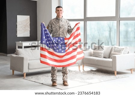 Young soldier with USA flag at home. Veterans Day celebration
