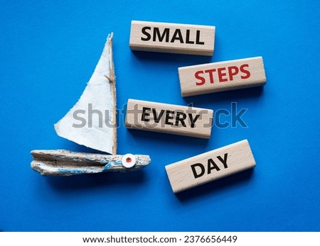 Small Steps Every Day symbol. Wooden blocks with words Small Steps Every Day. Beautiful blue background with boat. Business and Small Steps Every Day concept. Copy space.