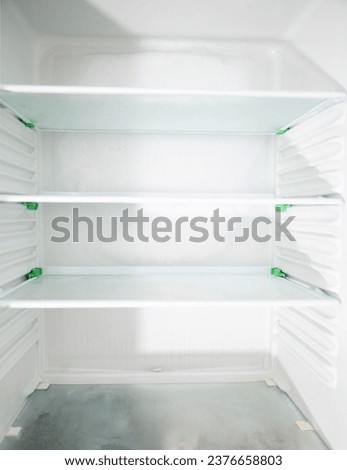 Ice and snow build up on the back wall of the refrigerator. Refrigerator failure, freon leak, temperature sensor defective. Royalty-Free Stock Photo #2376658803