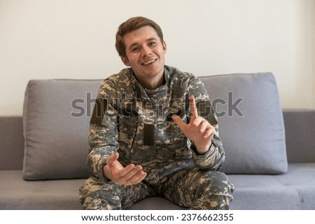 Headshot soldier in a military uniform looks to the camera confident and serious in studio