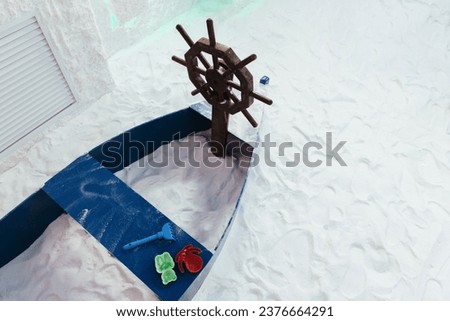 Children's sandbox boat in a salt cave. Details and decoration to decorate the space of the room. Royalty-Free Stock Photo #2376664291