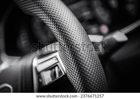 Modern Durable and Breathable Vehicle Steering Wheel Cover Material. Automotive Industry Theme. Royalty-Free Stock Photo #2376671257