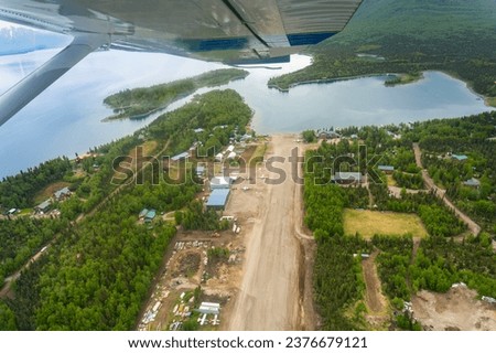 Aerial view of Port Alsworth, Alaska within Lake Clark National Park and Preserve. Private Port Alsworth Airport, public Wilder Natwick Airport, Hardenburg Bay. View from seaplane.  Royalty-Free Stock Photo #2376679121